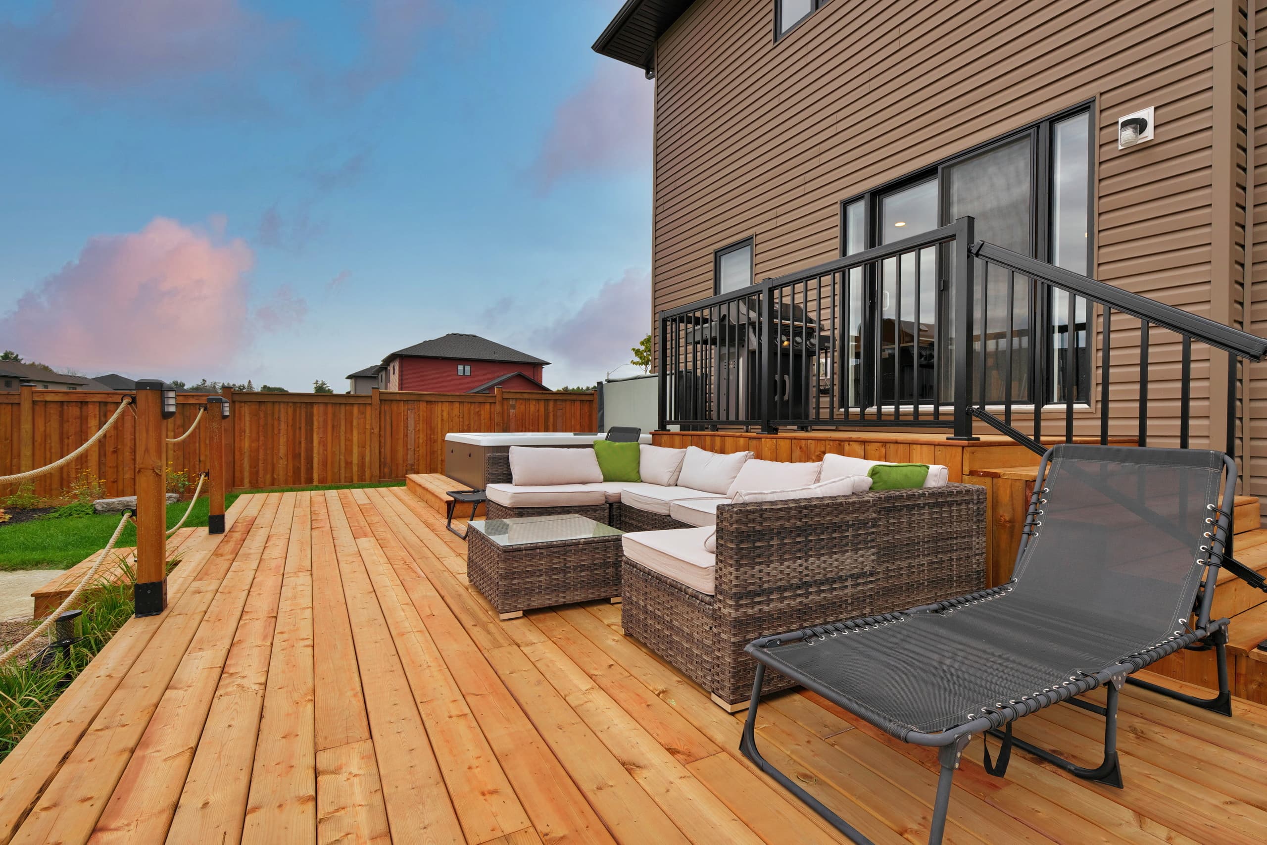 Owen’s House deck lounge and hot tub at dusk