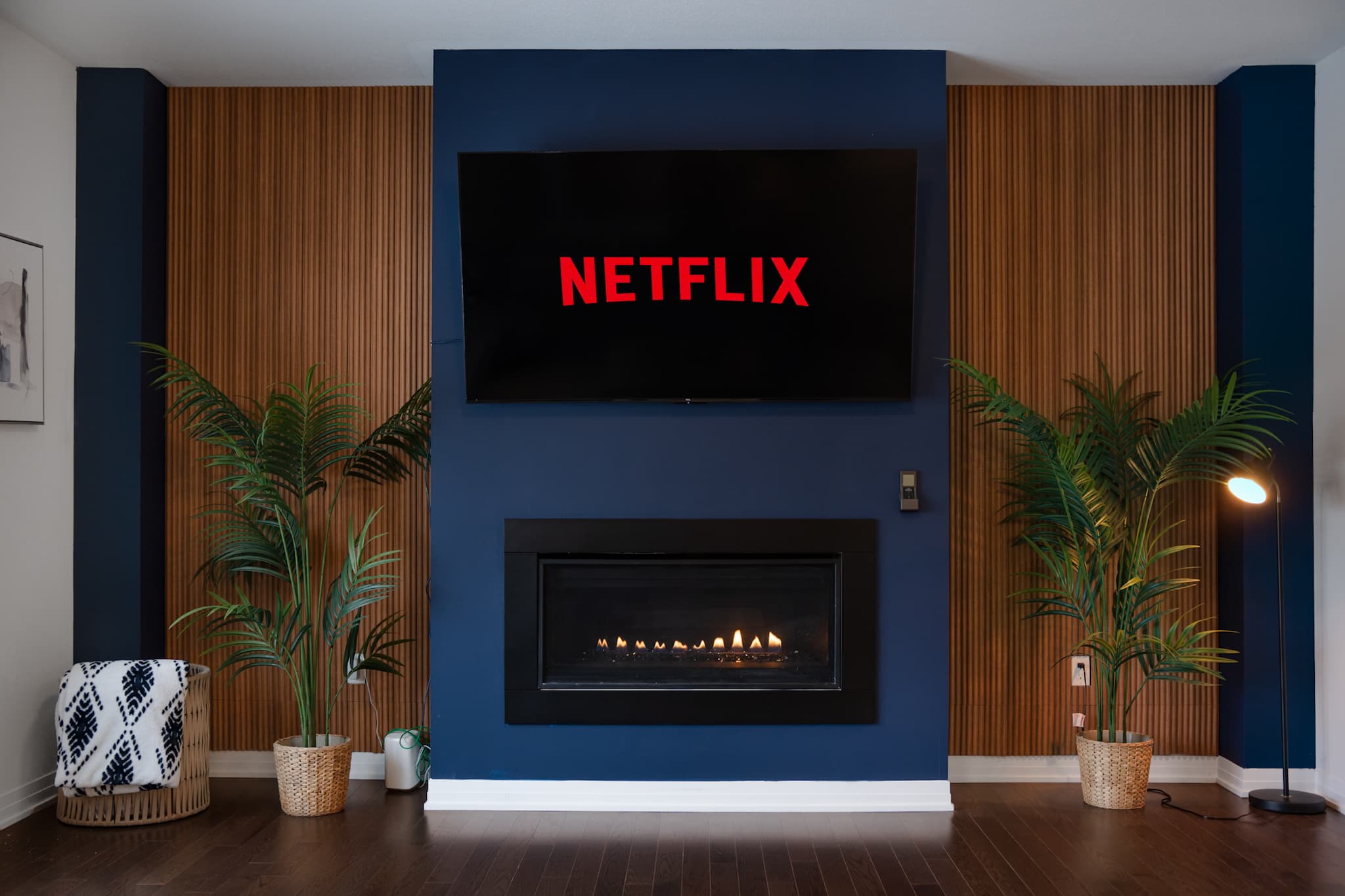 Priya’s Home living room with a blue accent wall and Netflix on the TV