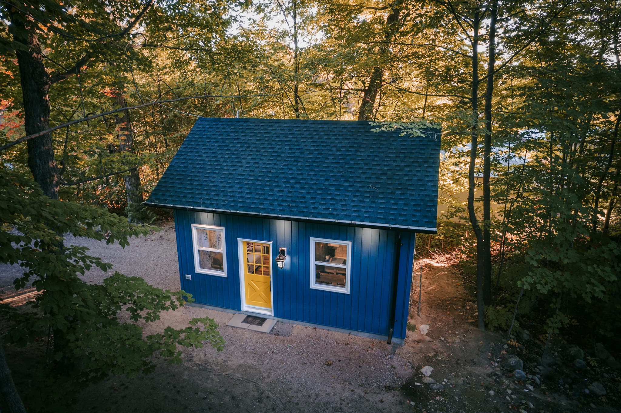 Wren’s Cabin, a blue one-bedroom waterfront cabin tucked into the trees on Lake Simcoe